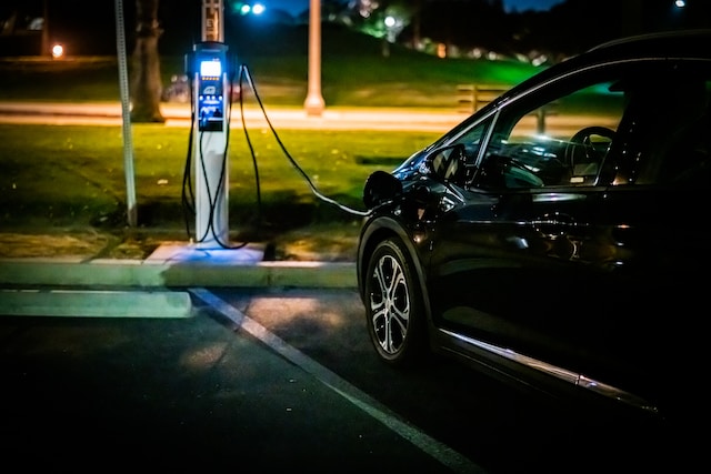 An EV charger that has been installed by an electrician is charging an electric car.