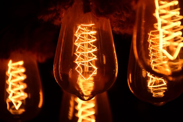 A cluster of five low-light lightbulbs that have been installed and maintained by an accredited electrician.