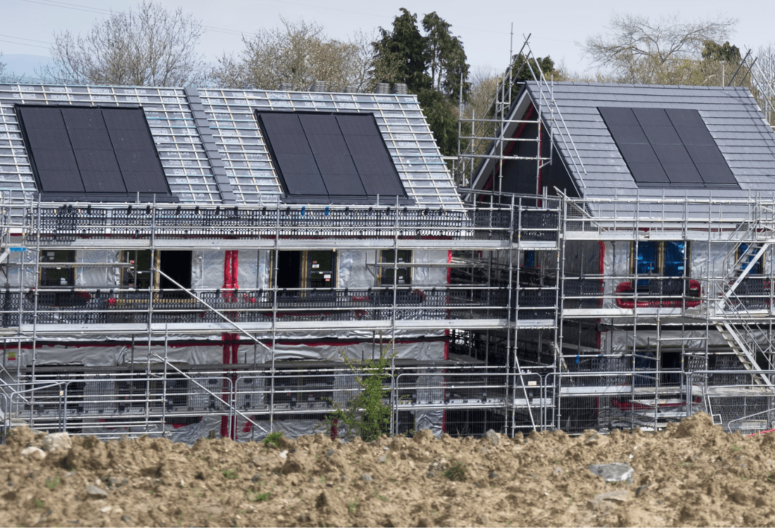 The roof of a house with solar panels that have been installed by an electrician after they added solar energy practices to their business.