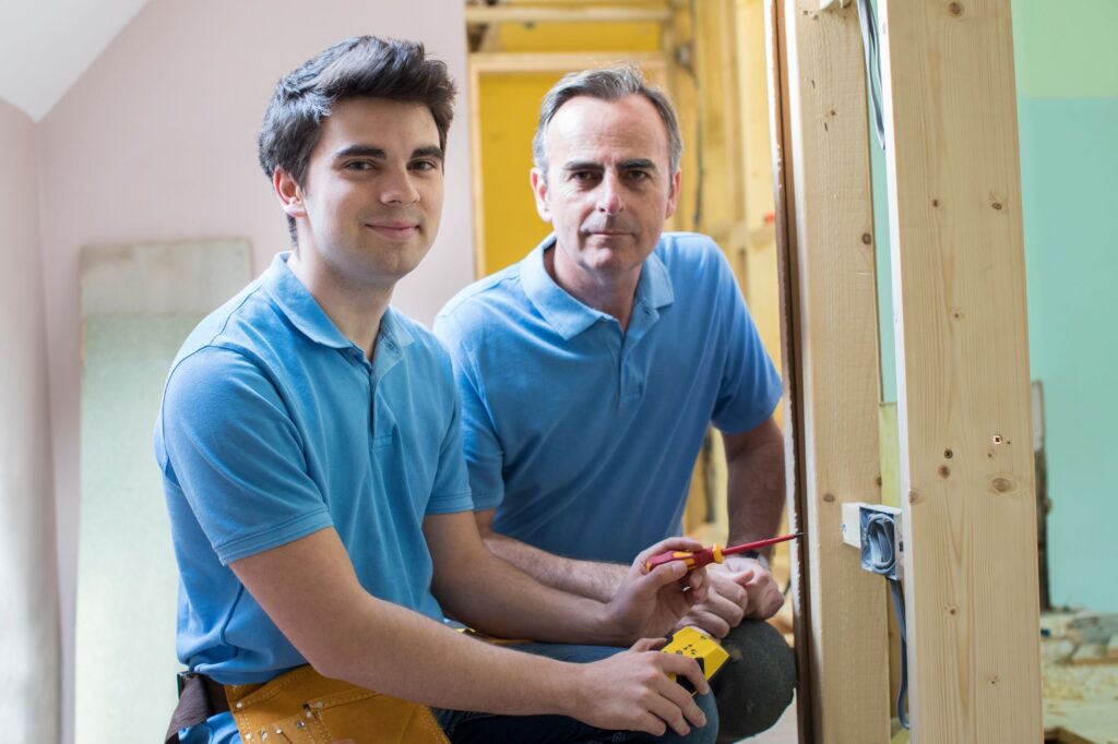 Two electricians working on a project together.