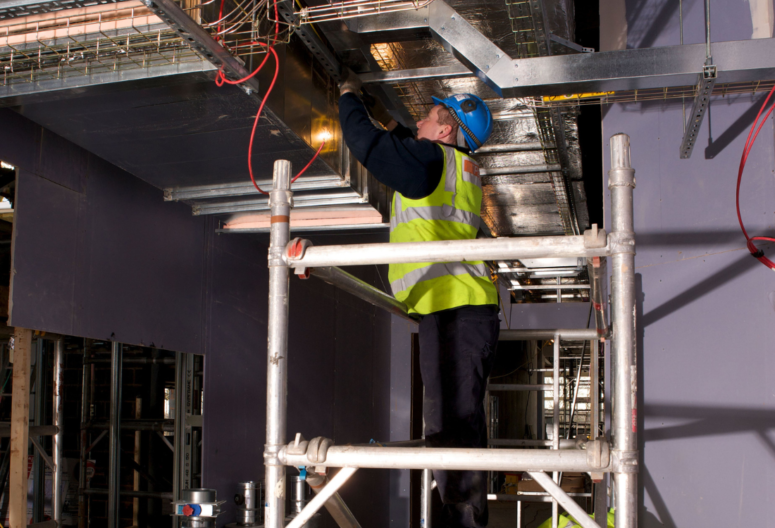 An electrician fitting a light