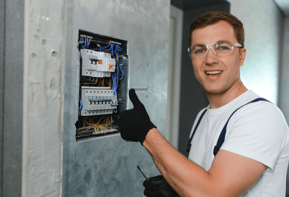 A person smiling confidently, representing success and satisfaction after learning how to become a self-employed electrician with PTT.